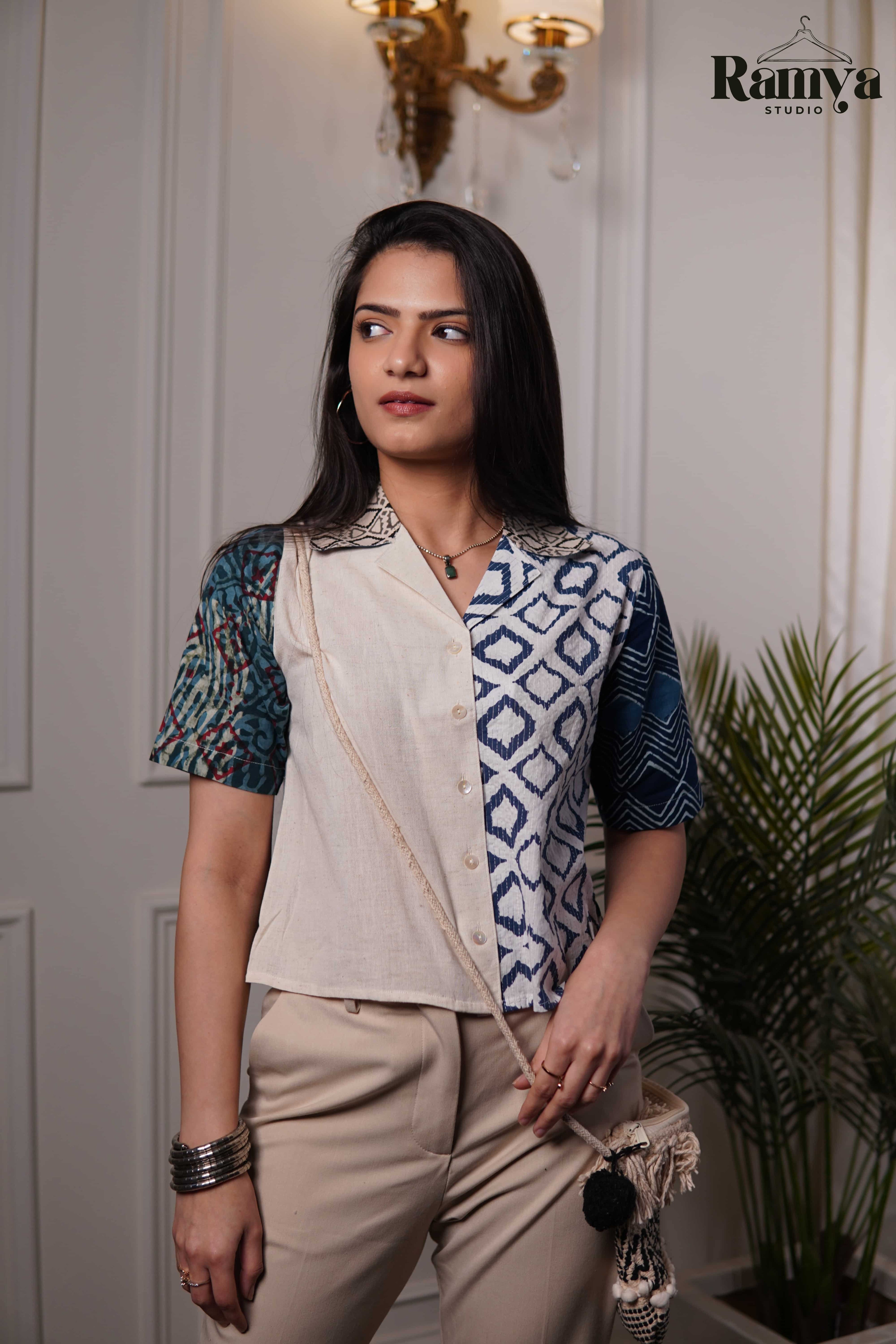 Stone Age Panel Shirt Top featuring a vertical half-and-half design with off-white cotton and navy geometric diamond block prints, accented by a printed collar and a teal-patterned sleeve.