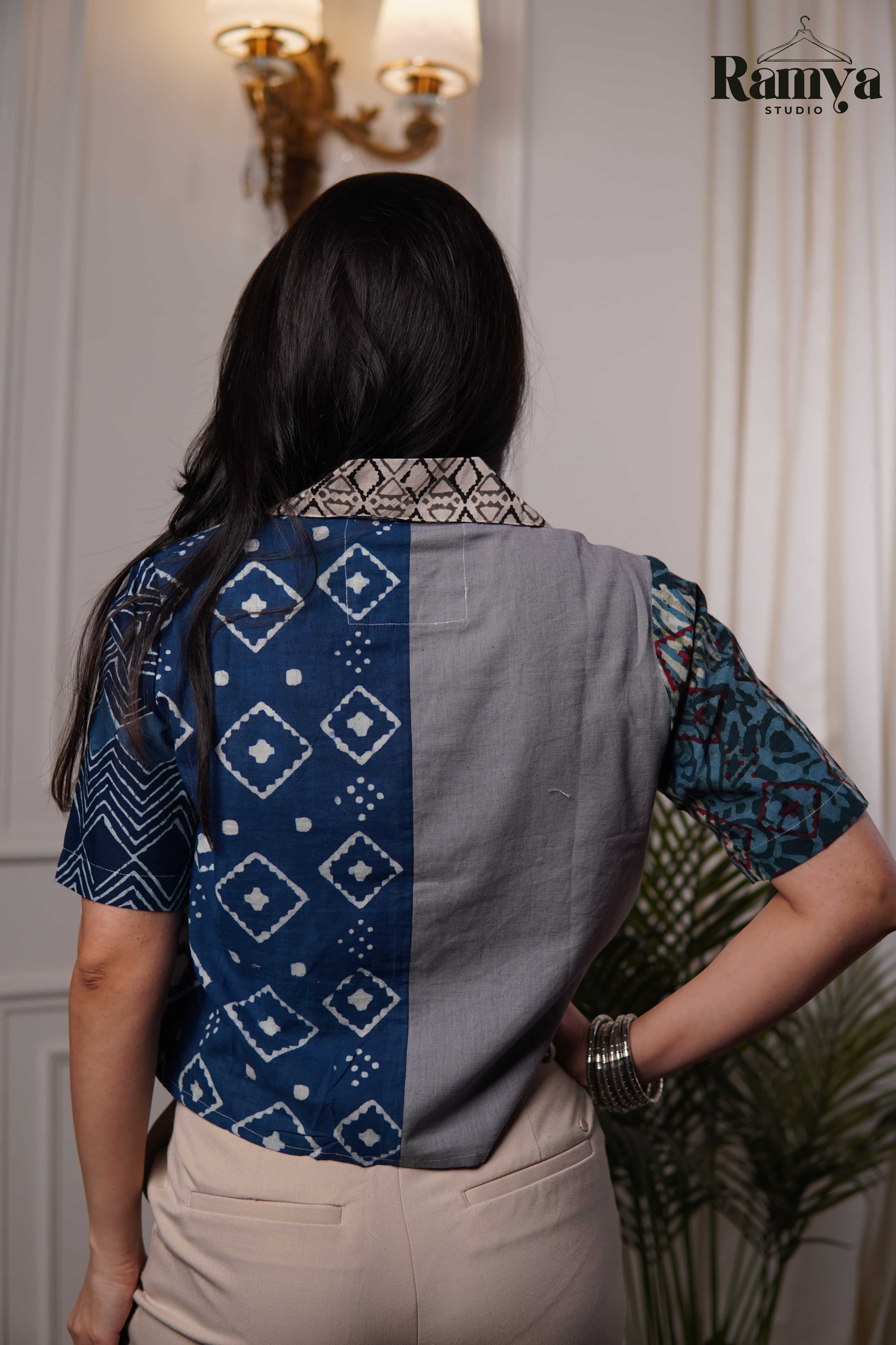 Stone Age Panel Shirt Top featuring a vertical half-and-half design with off-white cotton and navy geometric diamond block prints, accented by a printed collar and a teal-patterned sleeve.