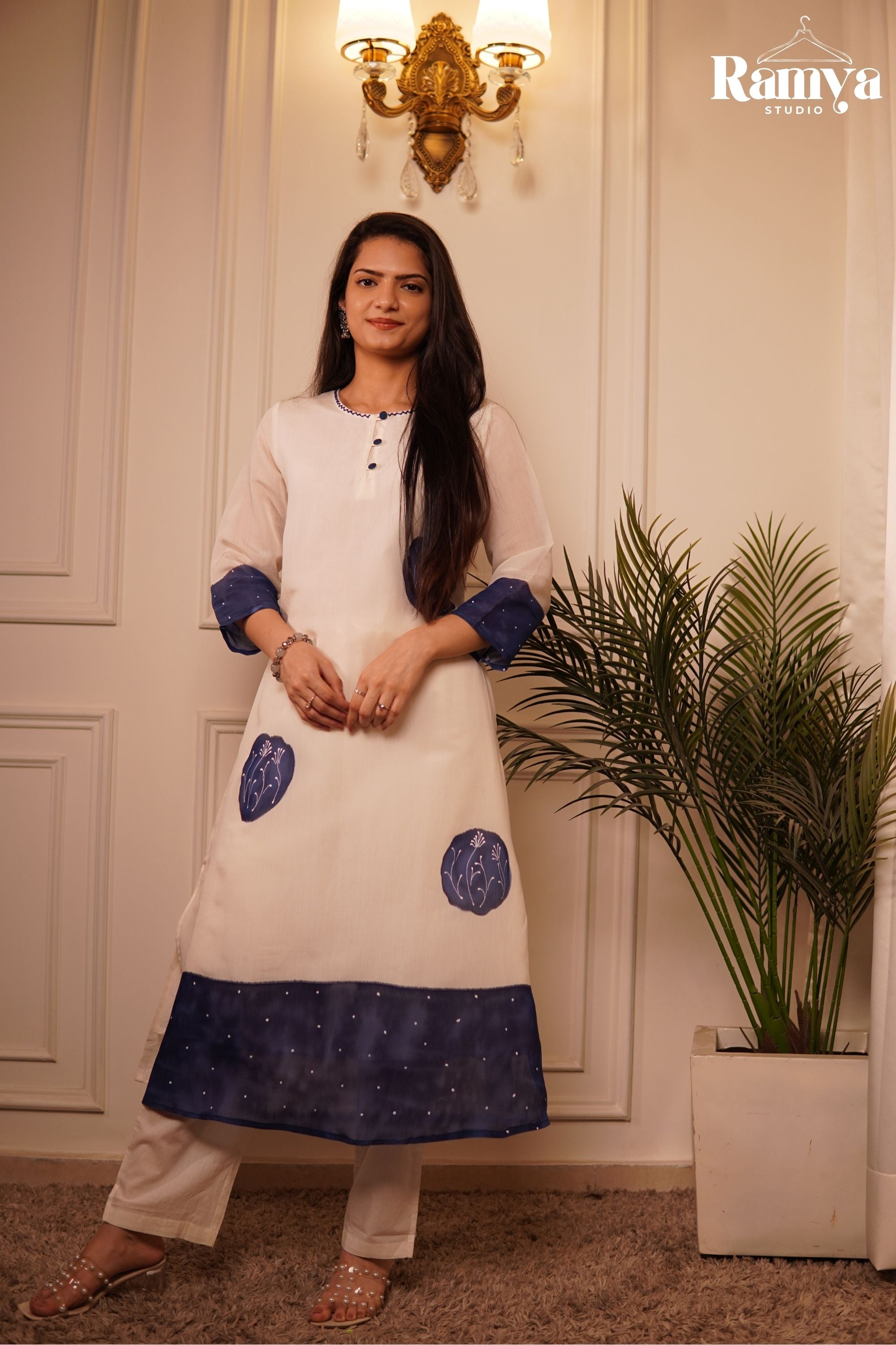 Ramya Studio ivory designer tunic and matching pants with graphic indigo block placements and botanical embroidery accents.