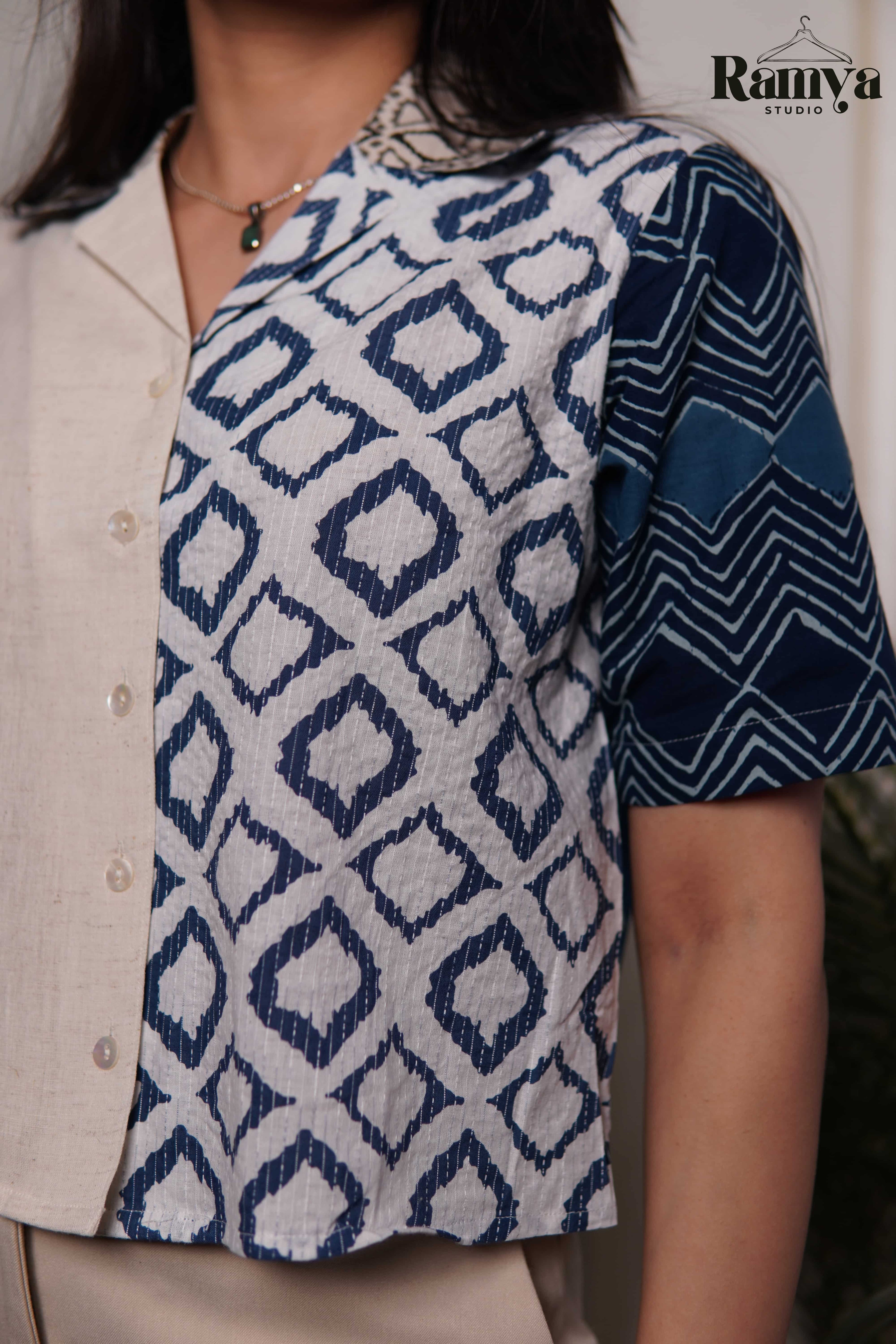 An artisanal paneled shirt top from Ramya Studio, combining earthy stone neutrals with heritage indigo block prints in a structured, modern silhouette.