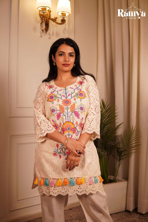 Full-length image of a women's 2-piece summer ethnic set in cream cotton Schiffli fabric with three-quarter sleeves and matching wide straight-fit trousers.
