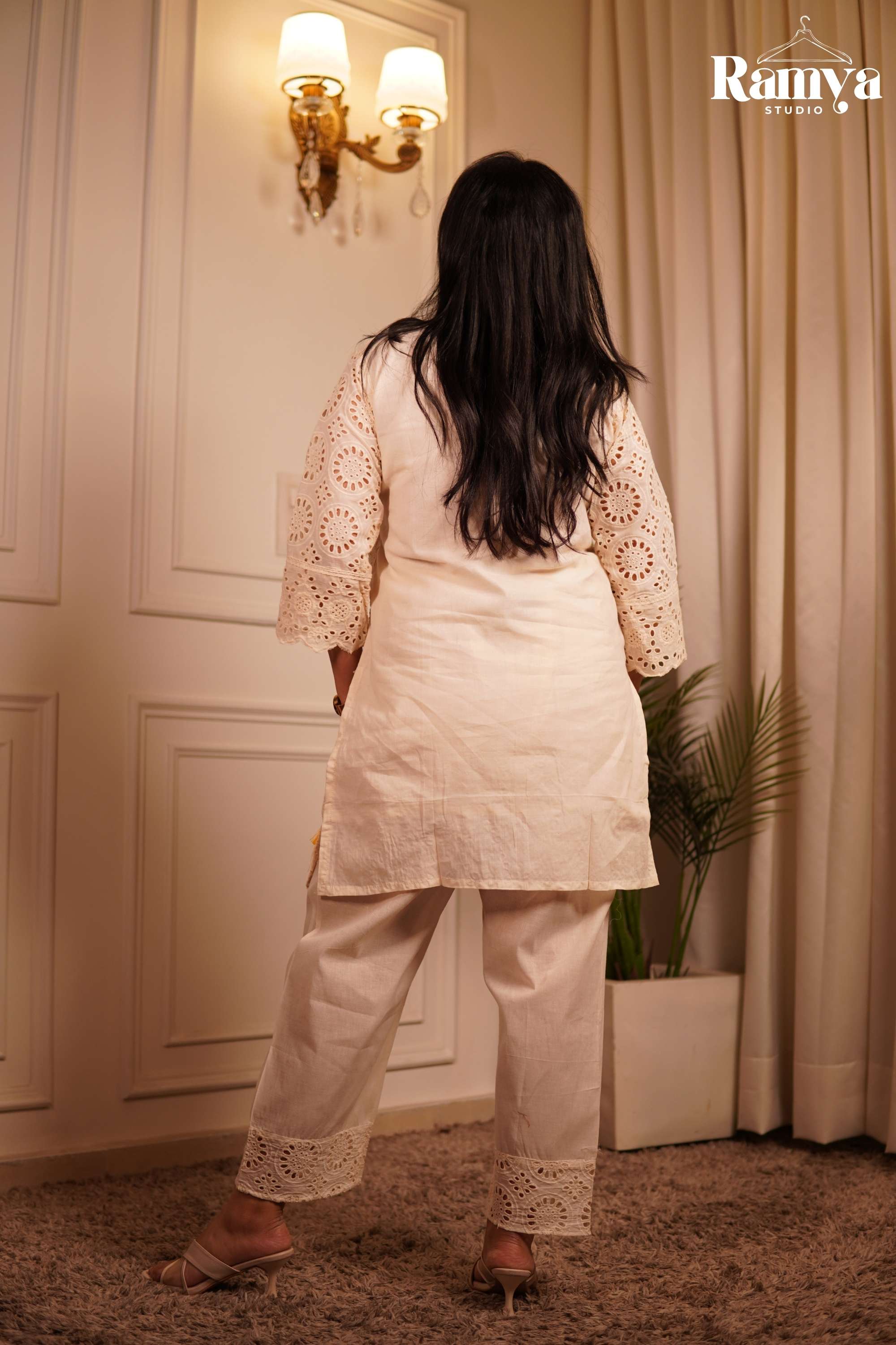 Ramya Studio ivory Hakoba short tunic and matching ankle-length pants with detailed geometric lace cut-outs.