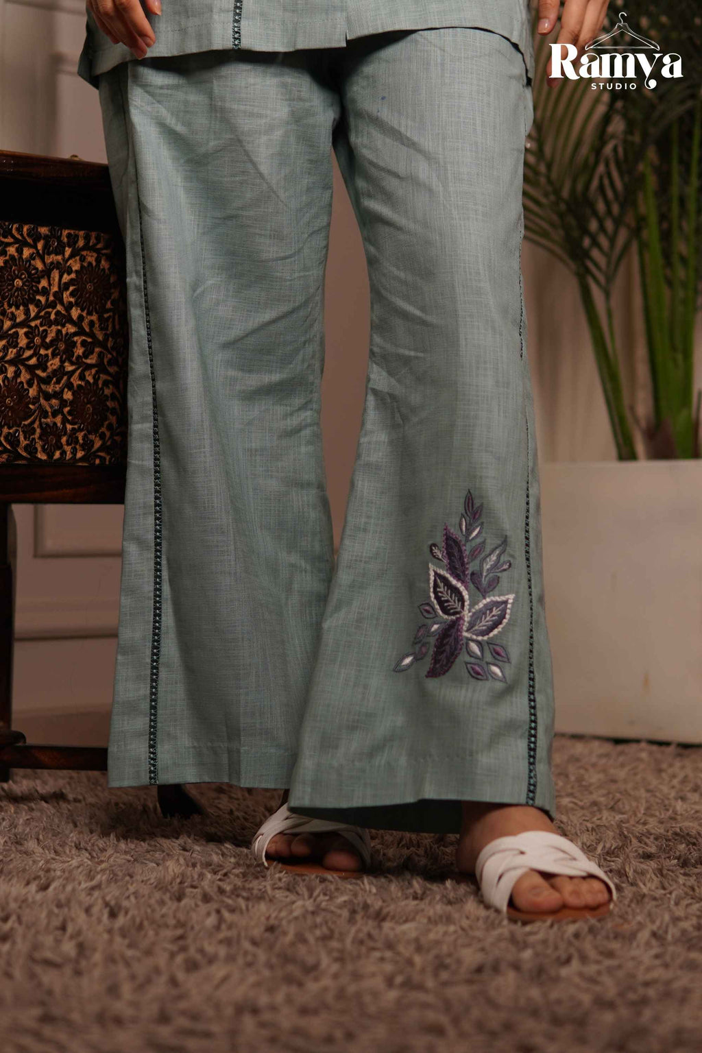 Ramya Exclusive Pistachio Poppy set showcasing embroidered wide-leg trousers with dark ladder-lace side seams