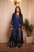 Modern Indian fusion wear: Deep blue tunic with animal print motifs paired with bold vertical striped culottes, styled with transparent block heels in a luxury interior setting.