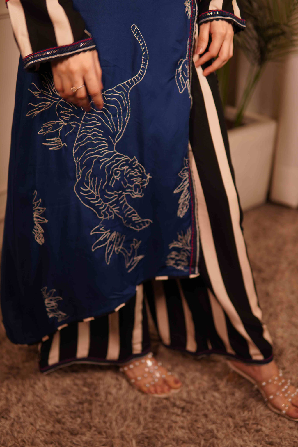 Navy blue outfit with white tiger embroidery and black and white striped pants.
