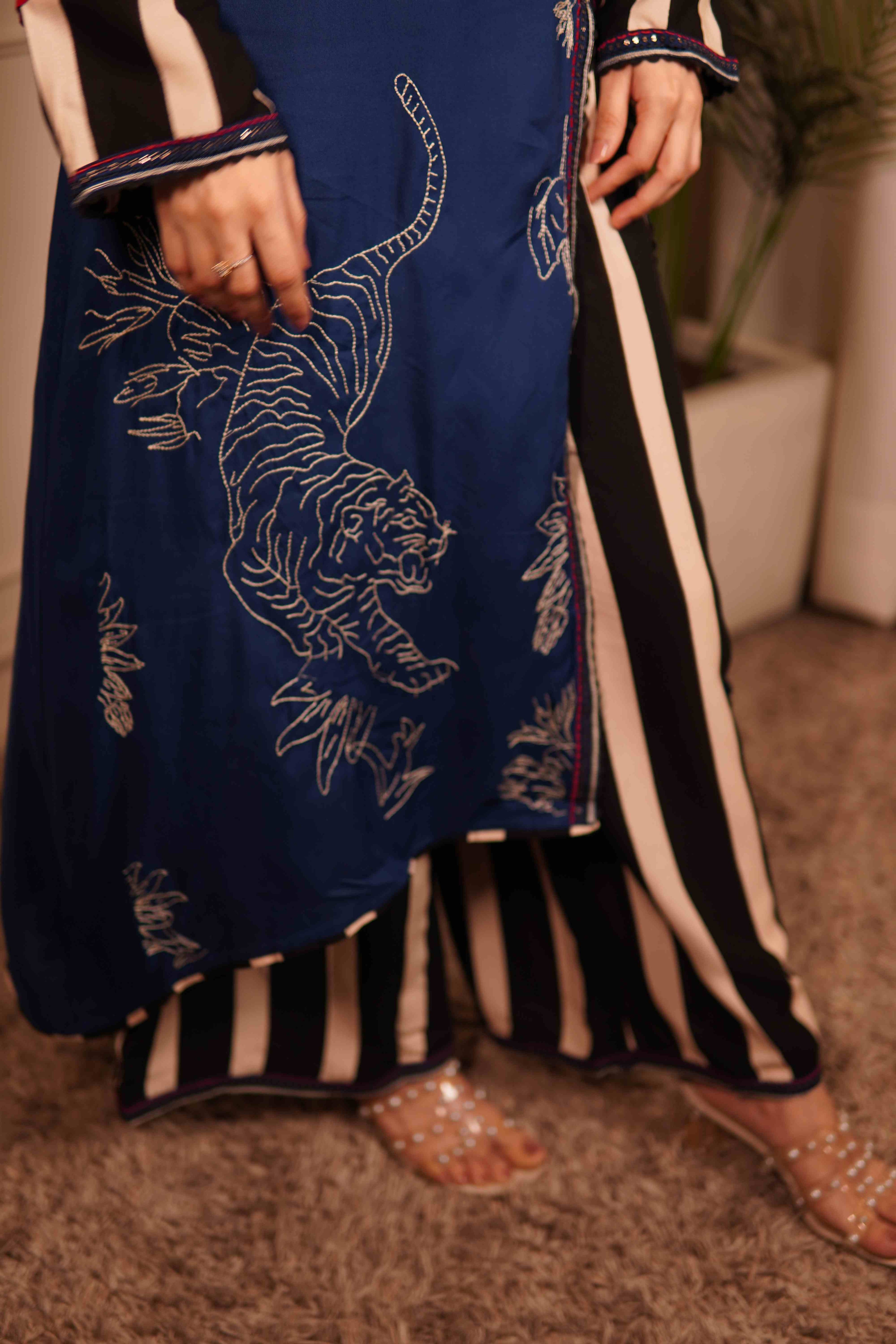 Navy blue outfit with white tiger embroidery and black and white striped pants.