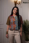 Terra Shirt Top featuring a colorful patchwork design with an olive green sleeve, a vibrant geometric red and mustard block-print panel, and a light blue floral block-print section.