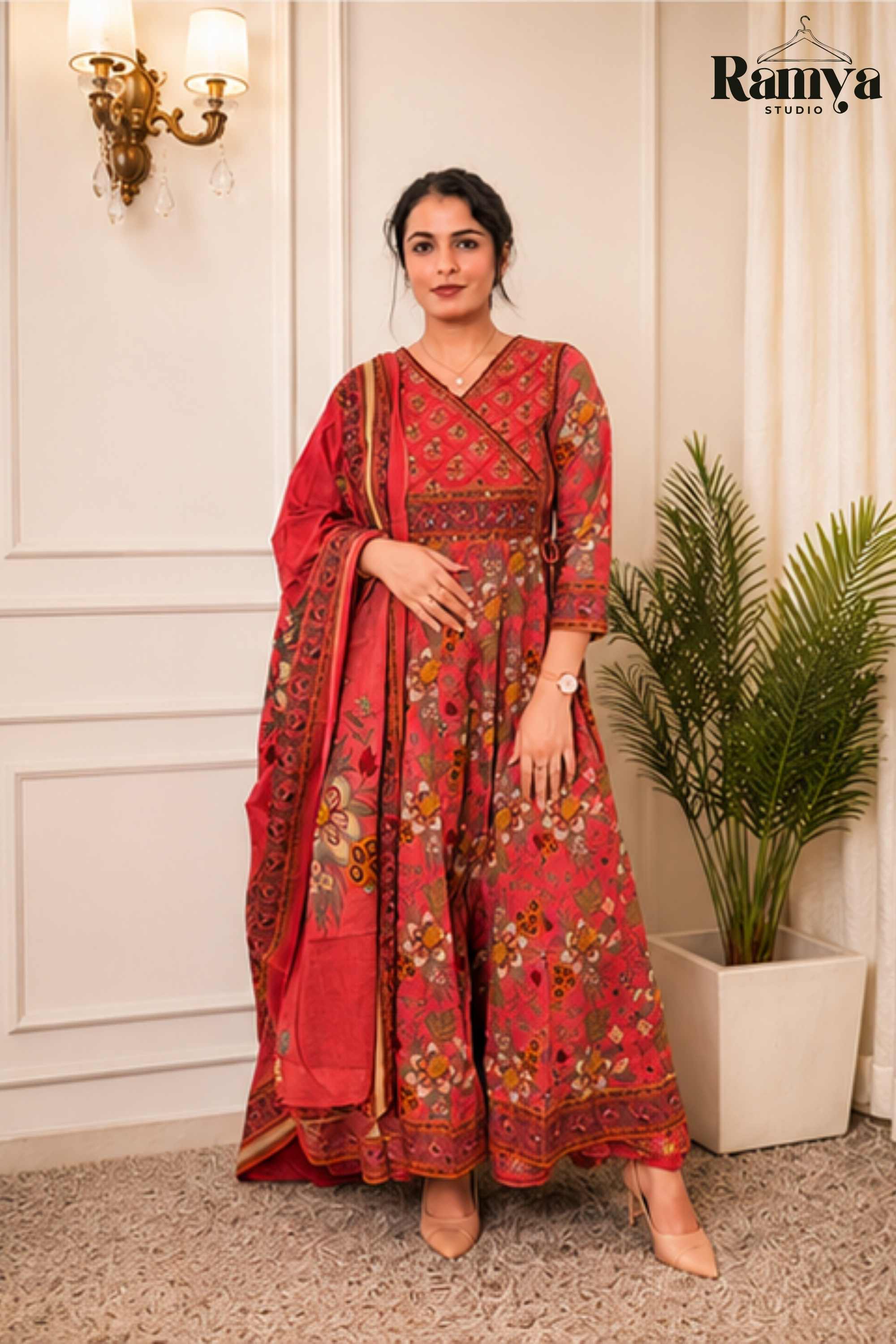 Full-length front view of a model in 'The Raani Anarkali' three-piece festive suit set, showcasing the flared hemline and botanical printed dupatta drape."