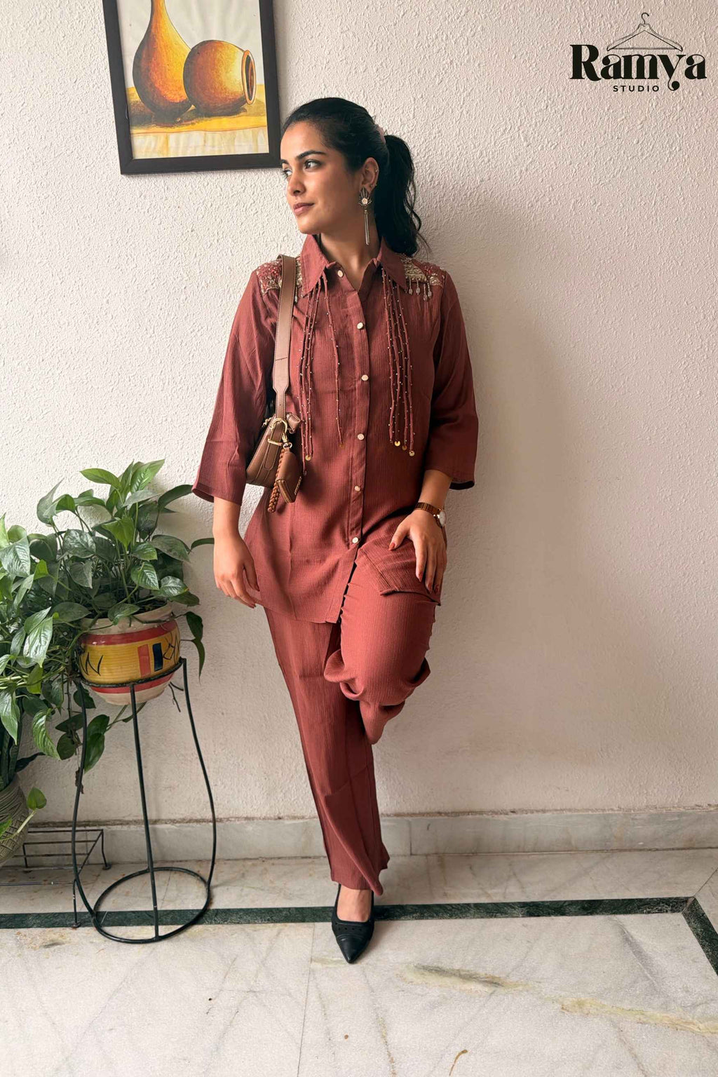 Full-length view of the 'Rumi' co-ord set paired with black pumps and a tan cross-body bag