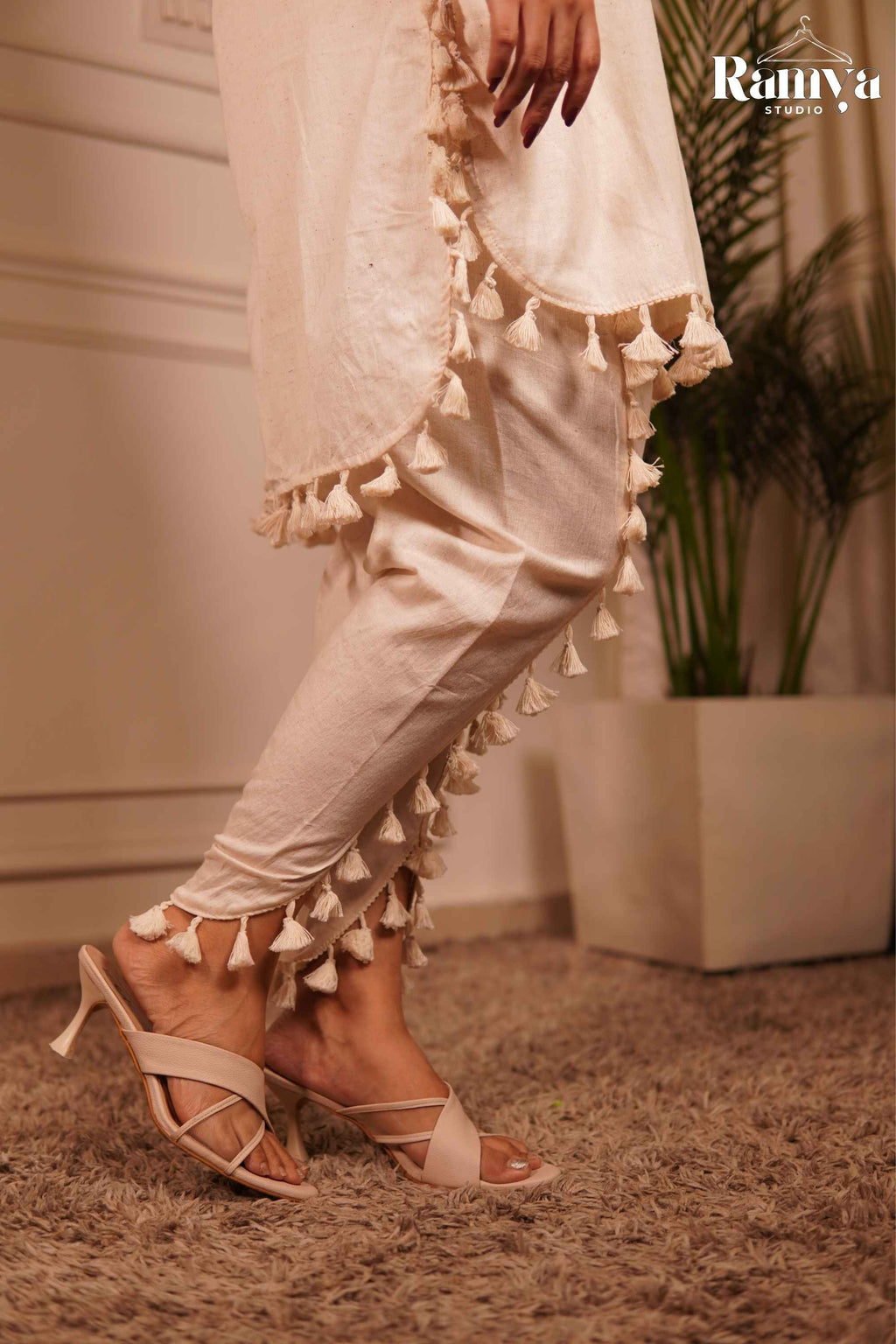 CLose up shot of the Tassle tale co-ord set and tulip pants with tassles