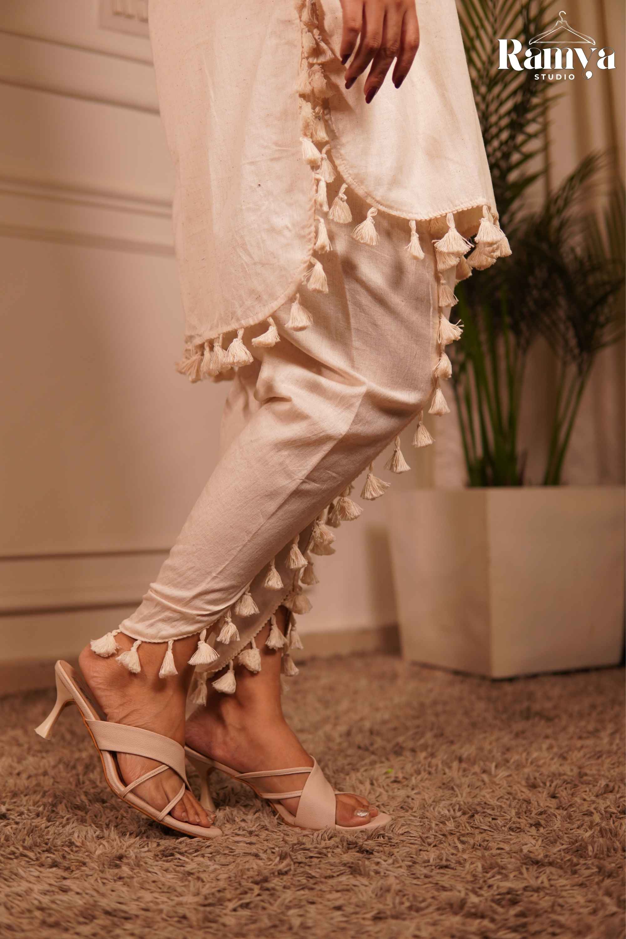CLose up shot of the Tassle tale co-ord set and tulip pants with tassles
