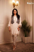 Full-length front view of a model wearing Ramya Studio's 'The Tassel-Tale Set', showcasing an off-white tunic with tassel fringes, a dark embroidered jacket, and tasseled tulip-slit pants.