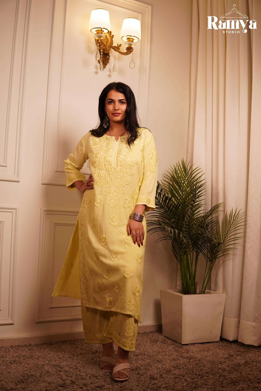 Full-length view of a model styling Ramya Studio's 'Lemonade on Labels' co-ord set, featuring a pastel lemon-yellow hand-embroidered Chikankari kurta and matching straight-cut trousers.
